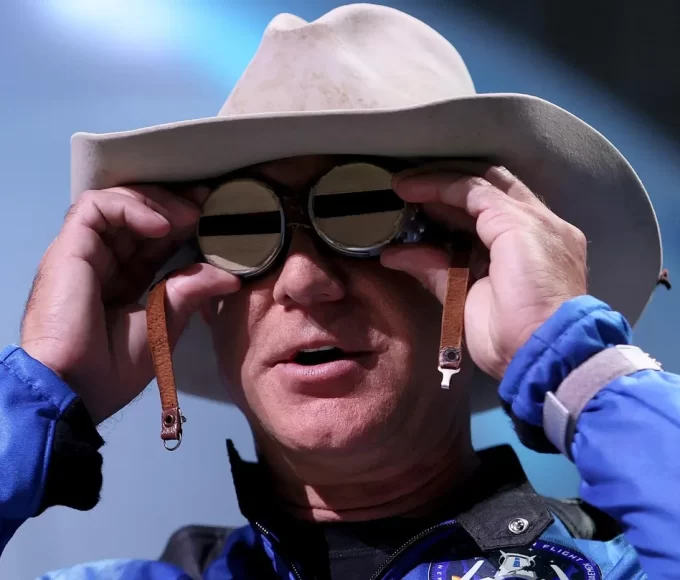 Jeff Bezos holds aviation glasses