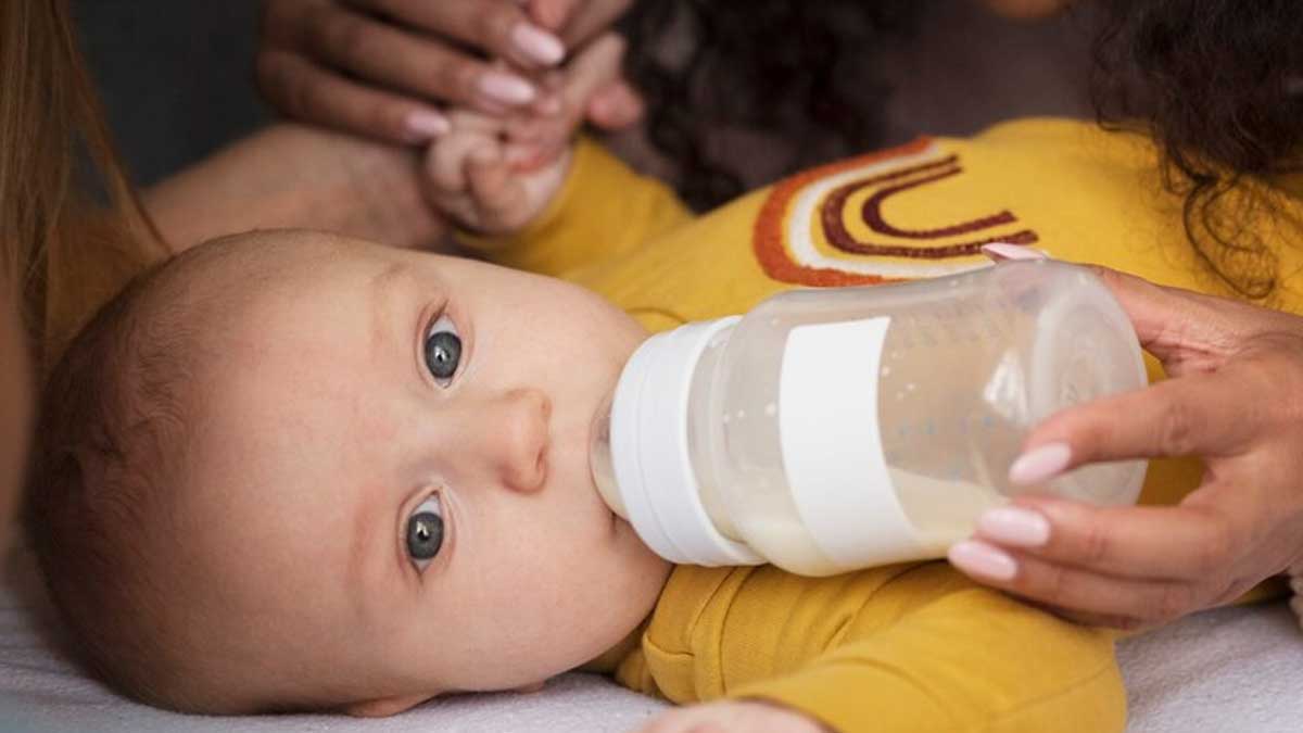 feeding baby with bottle of milk