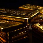 Gold and silver bars with falling prices