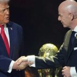 Trump and FIFA President Gianni Infantino beside World Cup trophy