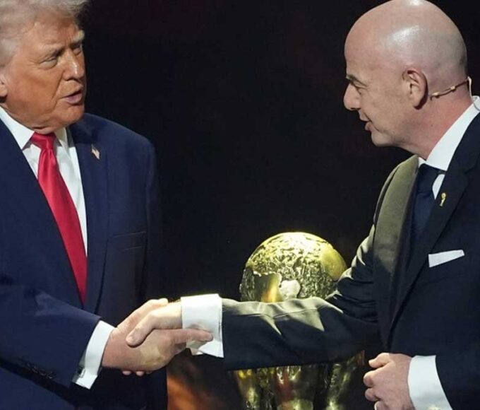 Trump and FIFA President Gianni Infantino beside World Cup trophy