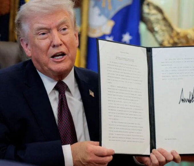 Trump holding a signed executive order