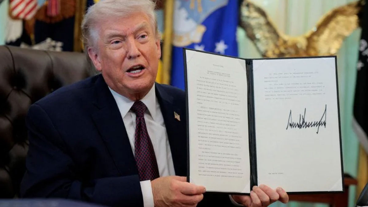 Trump holding a signed executive order